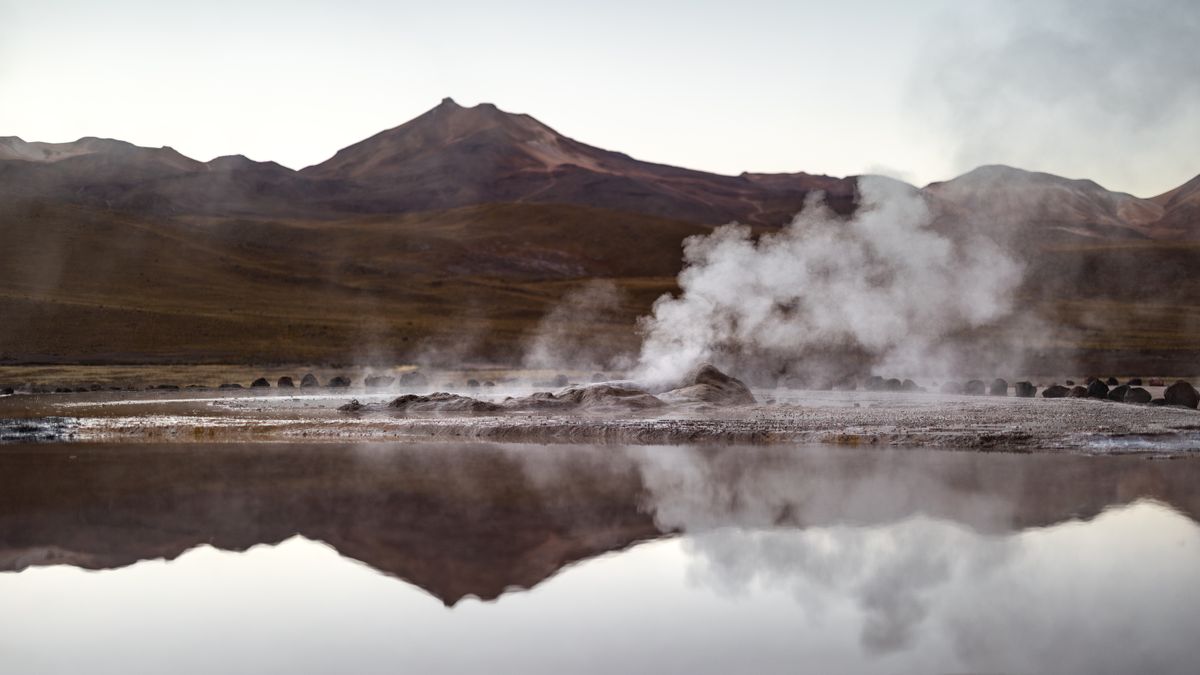 Steam rising from the El Tatio geyser field at dawn