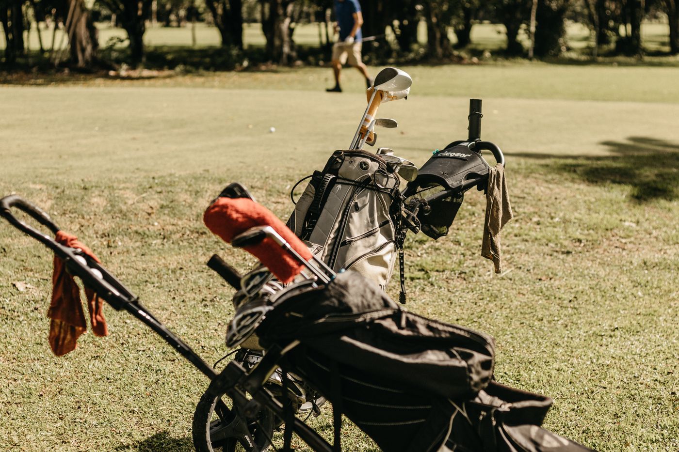 A golf bag and clubs on the course